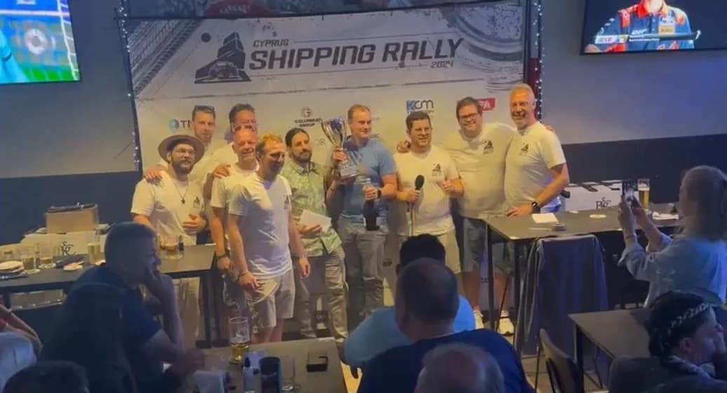 The 2024 winning crews lifting the trophy in front of the Shipping Rally backdrop