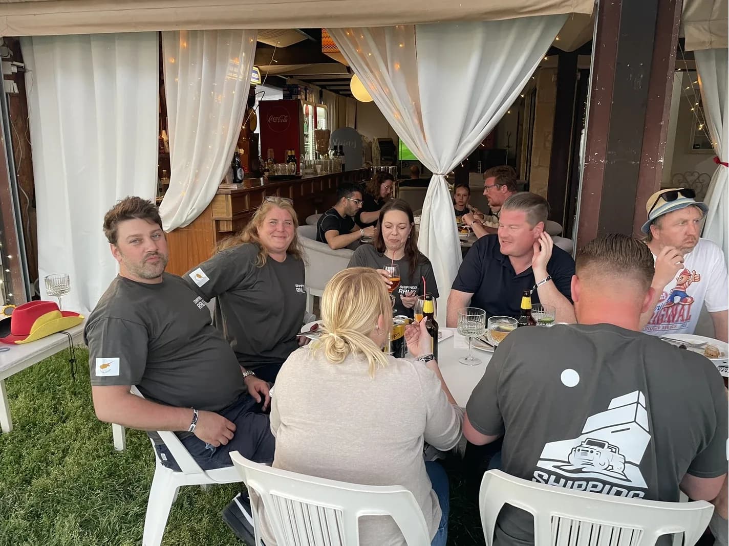 Teams in rally T-shirts at dinner after the course