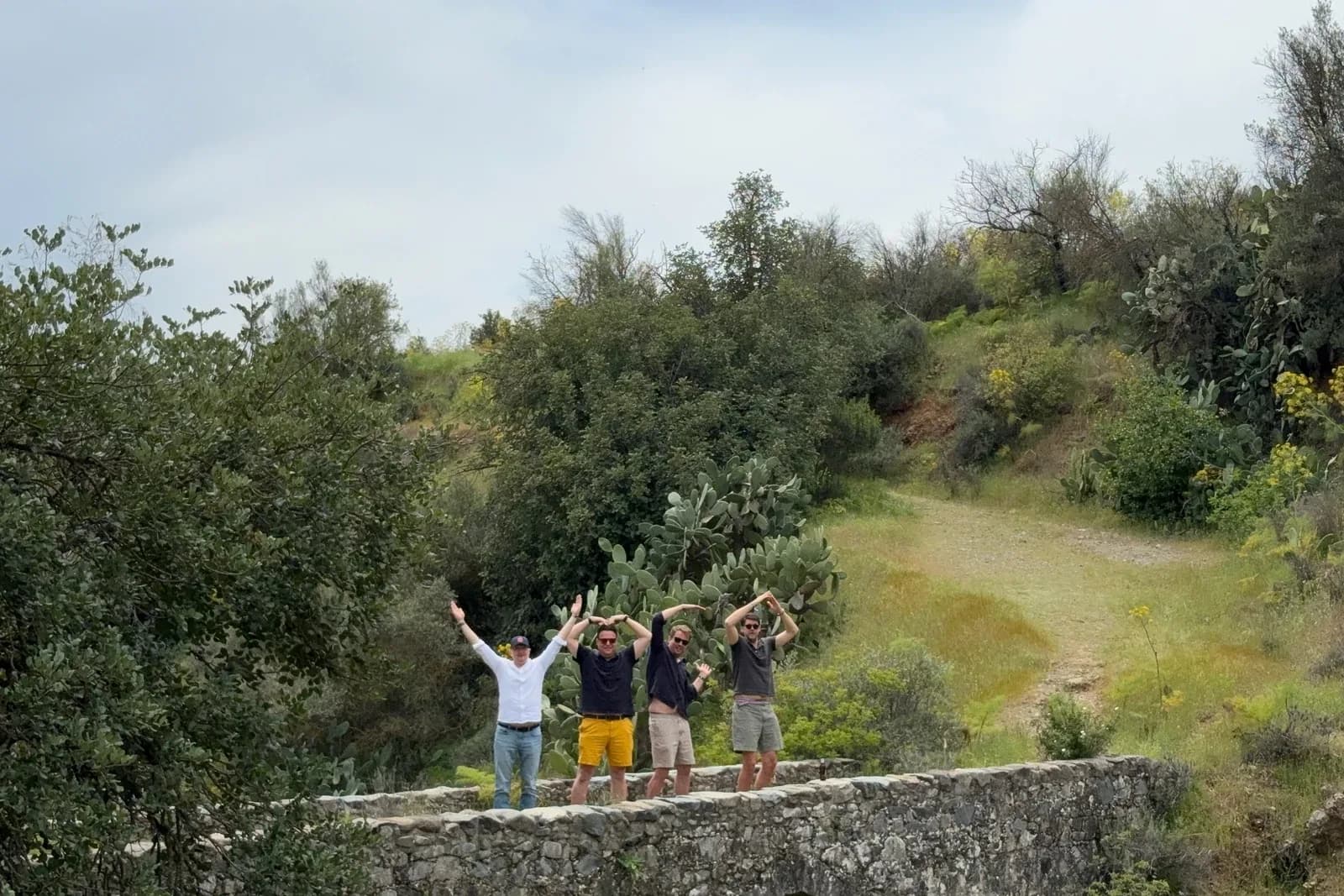A team with arms raised on the Venetian bridge