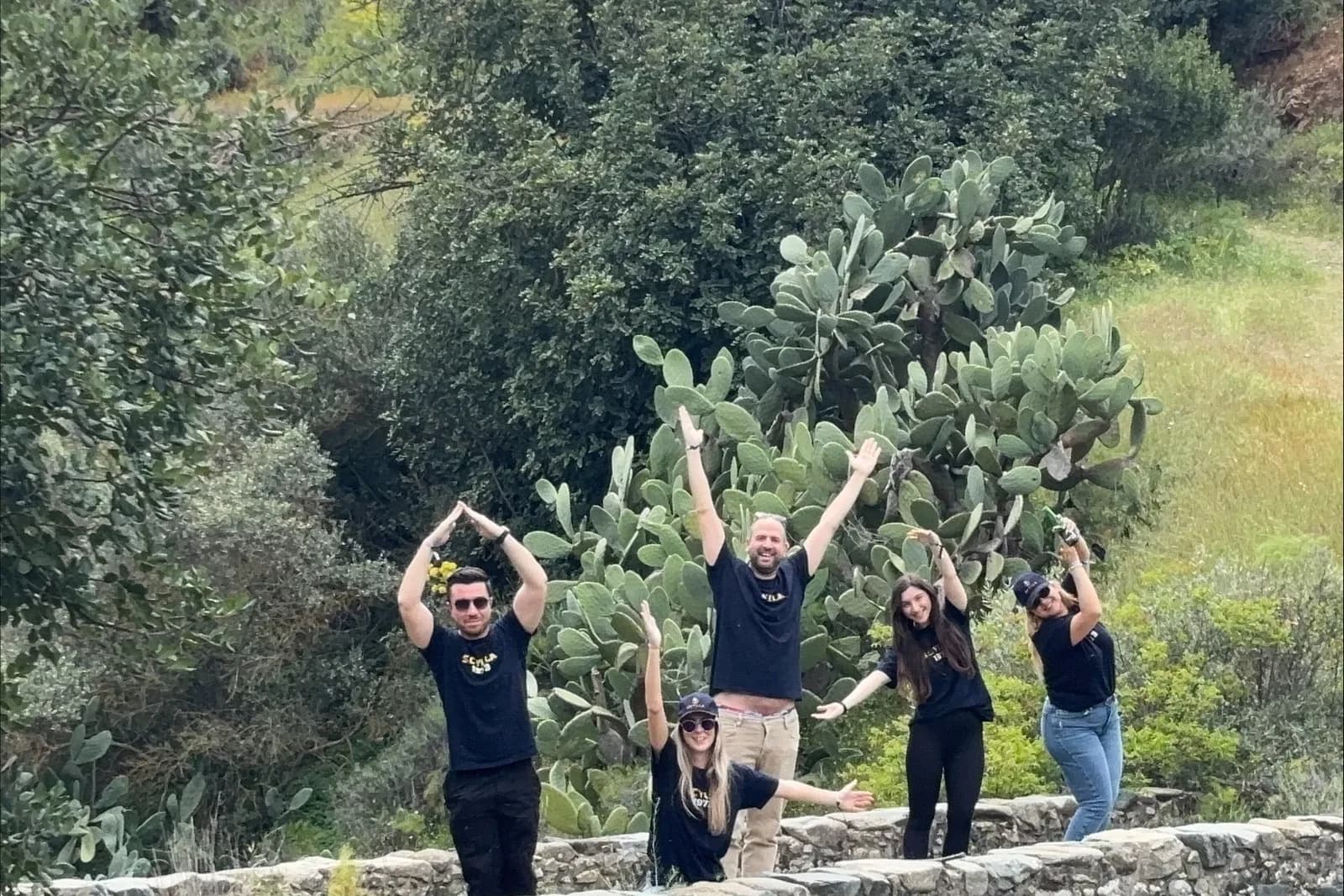 A team celebrating on the Akarnou Venetian bridge