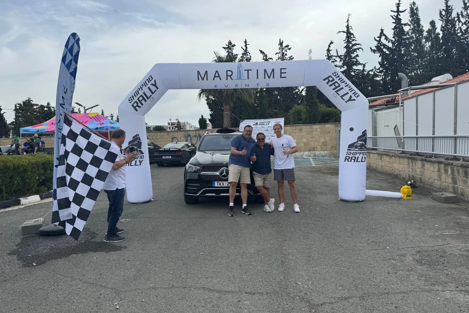 A chequered flag waved as a car crosses the line